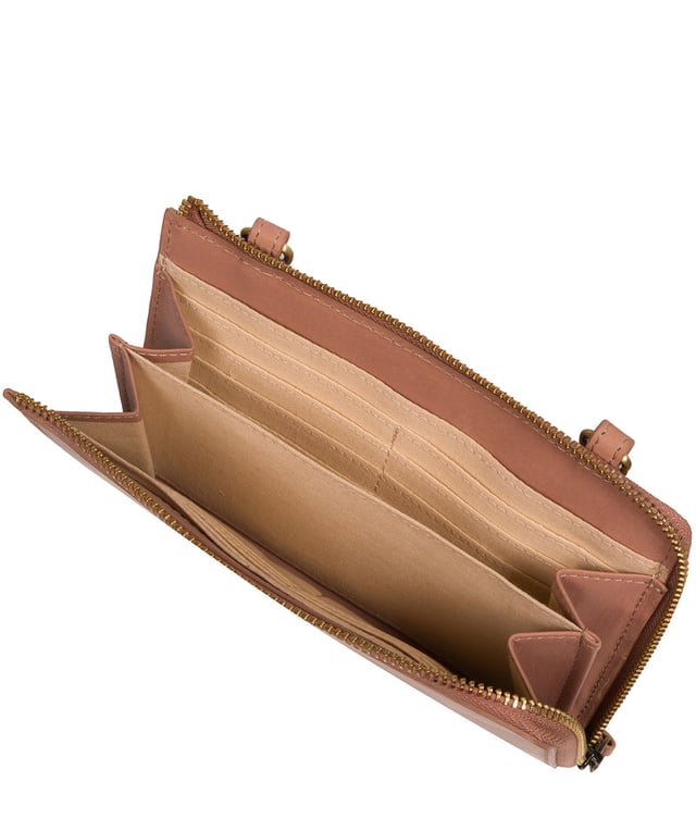 The perfect cross-over design, the 'Winnie' takes the classic purse design and transforms it into the perfect occasion accessory. This simply elegant design from Conkca's Signature Collection tansforms from crossbody and clutch bag with ease thanks to the detachable and adjustable slim leather strap with a maximum drop length of 75cm. Not forgetting the storage, with 16 card slots which line the 100% cotton interior and are concealed by a unique zip-round design.