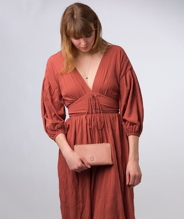 The perfect cross-over design, the 'Winnie' takes the classic purse design and transforms it into the perfect occasion accessory. This simply elegant design from Conkca's Signature Collection tansforms from crossbody and clutch bag with ease thanks to the detachable and adjustable slim leather strap with a maximum drop length of 75cm. Not forgetting the storage, with 16 card slots which line the 100% cotton interior and are concealed by a unique zip-round design.