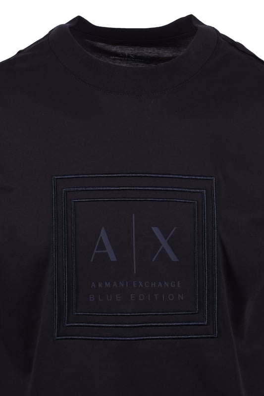 Armani Exchange Jersey T-shirt in Deep Navy
Elevate your casual wardrobe with the Armani Exchange Deep Navy Jersey T-Shirt. Crafted from 100% mercerised cotton, this regular-fit tee offers a refined take on everyday comfort. The mercerised treatment provides a subtle sheen and enhanced durability, ensuring a luxurious feel that lasts.
 
Designed for effortless style, this t-shirt features a classic round neck and short sleeves, making it a versatile staple for any occasion. The deep navy hue exudes sophistication, while the iconic Armani Exchange logo on the chest adds a touch of modern branding.
 
Features

Premium Mercerised Cotton: 100% cotton fabric with a polished finish and increased strength.
Classic Regular Fit: Comfortable and flattering silhouette.
Armani Exchange logo on the chest 
Deep Navy Color
Style code: XM000358