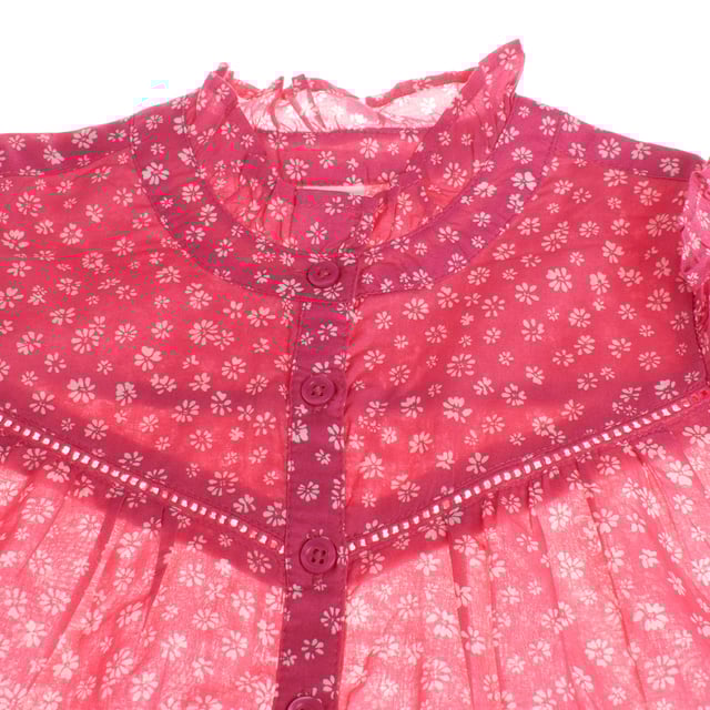 Girl's blouse with a delicate floral design that stands out for its romantic and feminine style.

 Made from a lightweight, semi-sheer fabric, this garment features a print of small flowers on a contrasting background on the yoke, adding a touch of depth.

 It features a front button closure that adds elegance and practicality.

 Long, slightly puffed sleeves end in elasticated cuffs for a comfortable fit.

 The gathered high neck and ruffles on the shoulders complete this charming and sophisticated look, ideal for special occasions or to add a unique touch to any outfit.
 Composition: 100% Cotton
 Care:
- Machine wash max. 30ºC..
 - Use similar colors in the wash.
 - Avoid the use of bleaches.
 - Dry at low temperature.
 - Iron at low temperature.
 - Do not dry clean.