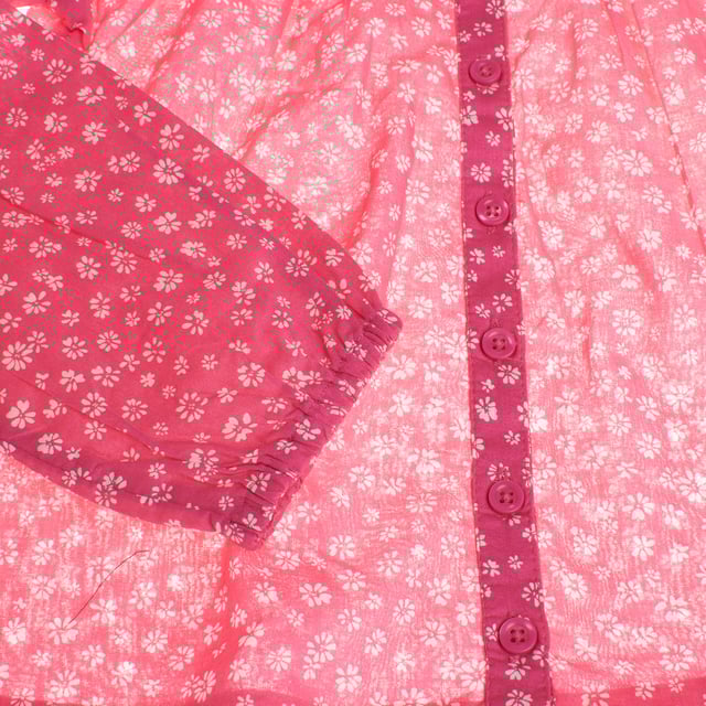 Girl's blouse with a delicate floral design that stands out for its romantic and feminine style.

 Made from a lightweight, semi-sheer fabric, this garment features a print of small flowers on a contrasting background on the yoke, adding a touch of depth.

 It features a front button closure that adds elegance and practicality.

 Long, slightly puffed sleeves end in elasticated cuffs for a comfortable fit.

 The gathered high neck and ruffles on the shoulders complete this charming and sophisticated look, ideal for special occasions or to add a unique touch to any outfit.
 Composition: 100% Cotton
 Care:
- Machine wash max. 30ºC..
 - Use similar colors in the wash.
 - Avoid the use of bleaches.
 - Dry at low temperature.
 - Iron at low temperature.
 - Do not dry clean.