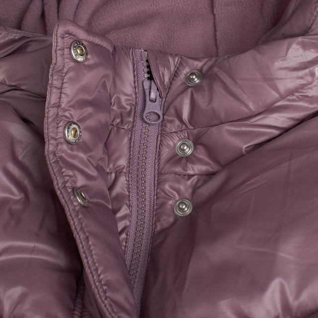 Winter jacket for girls designed to keep you warm and comfortable on the coldest days.

 The interior is lined with soft fleece, offering a warm and cozy feel.

 The outer layer is padded and waterproof, providing protection from rain and wind.

 It features a front zipper closure covered by a buttoned flap, which includes additional face mask-type protection.

 Slanted front pockets provide space for hand or small items, while the fleece-lined hood adds an extra touch of warmth.

 The long sleeves include elastic cuffs that fit comfortably, and on the inside, at waist level, there is an adjustable elastic with buttons to ensure a better fit and keep the body warm.

 It is an ideal garment for cold and rainy days, keeping girls warm and protected.
 Composition: Shell: 100% Polyester; Inner: 100% Polyester; Filling: 100% Polyester
 Care:
- Machine wash cold on delicate cycle.
 - Use non-chlorine bleach when necessary.
 - Do not dry clean.