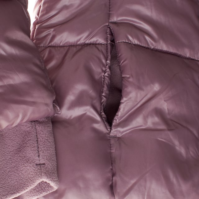 Winter jacket for girls designed to keep you warm and comfortable on the coldest days.

 The interior is lined with soft fleece, offering a warm and cozy feel.

 The outer layer is padded and waterproof, providing protection from rain and wind.

 It features a front zipper closure covered by a buttoned flap, which includes additional face mask-type protection.

 Slanted front pockets provide space for hand or small items, while the fleece-lined hood adds an extra touch of warmth.

 The long sleeves include elastic cuffs that fit comfortably, and on the inside, at waist level, there is an adjustable elastic with buttons to ensure a better fit and keep the body warm.

 It is an ideal garment for cold and rainy days, keeping girls warm and protected.
 Composition: Shell: 100% Polyester; Inner: 100% Polyester; Filling: 100% Polyester
 Care:
- Machine wash cold on delicate cycle.
 - Use non-chlorine bleach when necessary.
 - Do not dry clean.
