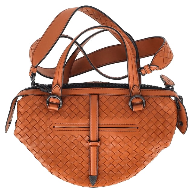 VINTAGE, RRP AS NEW
The Bottega Veneta Intrecciato Tambura Handbag in brown leather is a stunning example of the brand's signature craftsmanship and understated luxury. Expertly woven using the iconic Intrecciato technique, this Italian-made handbag features top handles and a detachable, adjustable shoulder strap for versatile wear. With its sleek, modern design and two-way zip fastening, it’s the perfect blend of sophistication and practicality for any occasion.

with Dust bag

Bottega Veneta Intrecciato Tambura Handbag in Brown Leather
Condition: Excellent
Signs of wear: No retail tag, No visible sign of wear., 
Packaging: Dust bag
Color: Brown
Material: Leather | leather
Size: One Size | One Size
Measurements: Width: 200; Height: 180; Length: 280; Handle drop: 110; Strap length: 0
SKU: NAPPUGBBA447438W