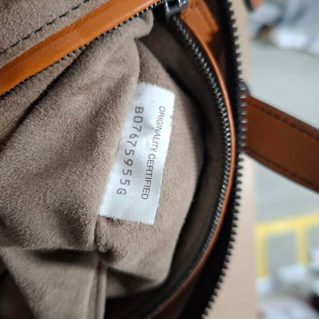 VINTAGE, RRP AS NEW
The Bottega Veneta Intrecciato Tambura Handbag in brown leather is a stunning example of the brand's signature craftsmanship and understated luxury. Expertly woven using the iconic Intrecciato technique, this Italian-made handbag features top handles and a detachable, adjustable shoulder strap for versatile wear. With its sleek, modern design and two-way zip fastening, it’s the perfect blend of sophistication and practicality for any occasion.

with Dust bag

Bottega Veneta Intrecciato Tambura Handbag in Brown Leather
Condition: Excellent
Signs of wear: No retail tag, No visible sign of wear., 
Packaging: Dust bag
Color: Brown
Material: Leather | leather
Size: One Size | One Size
Measurements: Width: 200; Height: 180; Length: 280; Handle drop: 110; Strap length: 0
SKU: NAPPUGBBA447438W