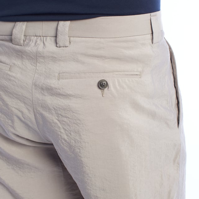Chino pants from Emporio Armani, designed for those looking for a perfect combination of elegance and contemporary style.

 Characteristics:

 - Fit: Tapered fit, with front darts that add structure and a comfortable fit at the top, narrowing towards the ankles for a modern and streamlined silhouette.
 - Closure: Button and zipper, ensuring practicality and ease of use.

 Pockets:

 - Two functional side pockets.
 - Back welt pockets with button closure highlight the clean and sophisticated design.

 - Style: Minimalist and versatile design, ideal for combining on casual or semi-formal occasions.

 A pair of trousers that stands out for its impeccable and refined workmanship, perfectly adapting to the modern man.
 Composition: Fabric: 76% Silk, 24% Polyamide
 Care:
- Machine wash on gentle cycle.
 - Use similar colors in the wash.
 - Avoid the use of bleaches.
 - Dry at low temperature in the dryer.
 - Iron at low temperature.
 - Do not dry clean.