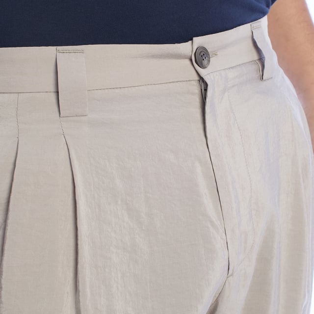 Chino pants from Emporio Armani, designed for those looking for a perfect combination of elegance and contemporary style.

 Characteristics:

 - Fit: Tapered fit, with front darts that add structure and a comfortable fit at the top, narrowing towards the ankles for a modern and streamlined silhouette.
 - Closure: Button and zipper, ensuring practicality and ease of use.

 Pockets:

 - Two functional side pockets.
 - Back welt pockets with button closure highlight the clean and sophisticated design.

 - Style: Minimalist and versatile design, ideal for combining on casual or semi-formal occasions.

 A pair of trousers that stands out for its impeccable and refined workmanship, perfectly adapting to the modern man.
 Composition: Fabric: 76% Silk, 24% Polyamide
 Care:
- Machine wash on gentle cycle.
 - Use similar colors in the wash.
 - Avoid the use of bleaches.
 - Dry at low temperature in the dryer.
 - Iron at low temperature.
 - Do not dry clean.