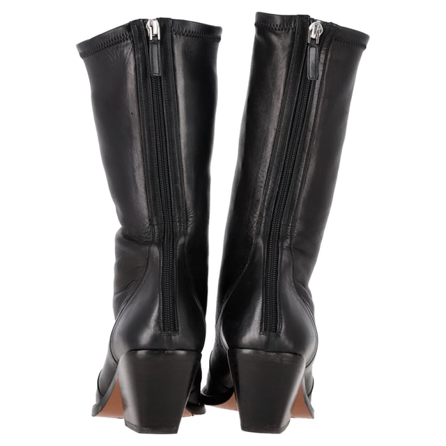 VINTAGE, RRP AS NEW
The Givenchy Slant-Heel Mid-Calf Boots in black leather are a bold and modern statement piece that combines luxury with contemporary edge. Crafted from smooth black leather, these boots feature a distinctive slanted heel that adds a unique architectural element to their sleek design. The mid-calf length offers versatility, making them perfect for both casual and dressed-up looks. With their refined silhouette and edgy details, these boots are ideal for those who want to elevate their footwear collection with a touch of sophistication and attitude.

Styling Tip:
Pair the Givenchy Slant-Heel Mid-Calf Boots with tailored trousers or a midi skirt for a chic and balanced look. For a more casual vibe, wear them with skinny jeans or a leather jacket. These boots also pair perfectly with a sleek, form-fitting dress, adding a strong contrast that brings an edgy element to a feminine silhouette. Whether dressed up or down, the unique slanted heel is sure to make a stylish statement wherever you go.

 Givenchy Slant-Heel Mid-Calf Boots in Black Leather

Condition: Very good
Signs of wear: Minor markings, Lightly used but very well maintained. Minor mark at soles & creasing, light scuffing at the soles and heels.
Packaging: None
Color: Black
Material: Leather | leather
Size: IT | 39
Measurements: Heel height: 60; Insole length: 250
SKU: NAPPUGBSH457178W