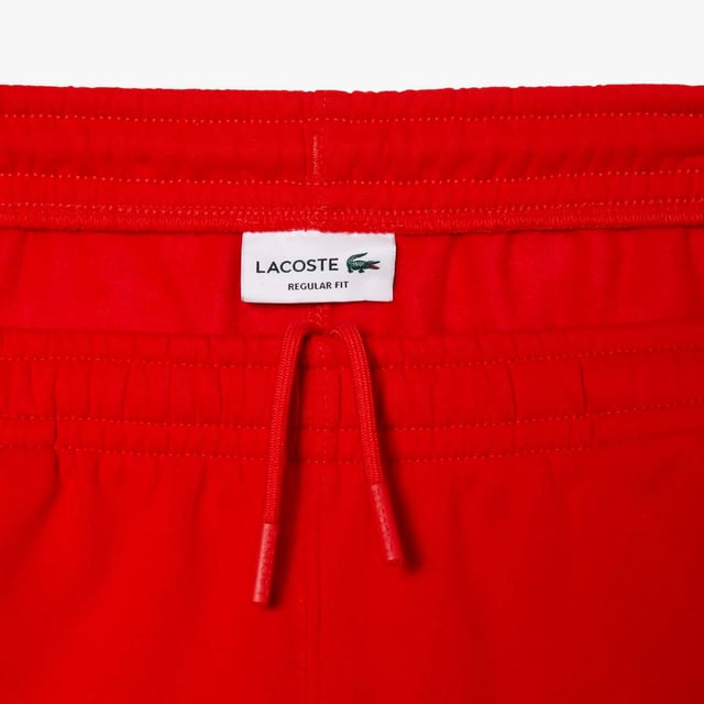 Men's Lacoste Cotton Flannel Shorts.- Regular fit, straight cut: Timeless.- Branded drawstring at waist: Adjustable. It's all in the details.- Side pockets, branded stripe down sides: Little details that make a big difference.- Embroidered crocodile on front: Our authentic signature.- Brushed cotton flannel with fleece lining: Super-soft. Material: 80% Cotton, 20% Polyester. Ref: GH5074S5H.