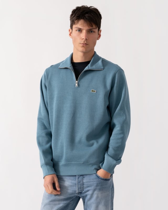 Ribbed cotton interlock
Zip ribbed stand up polo collar
Tone-on-tone ribbed finishes at bottom of garment and sleeve ends
Classic Fit
Embroidered green crocodile on chest
Cotton (100%)