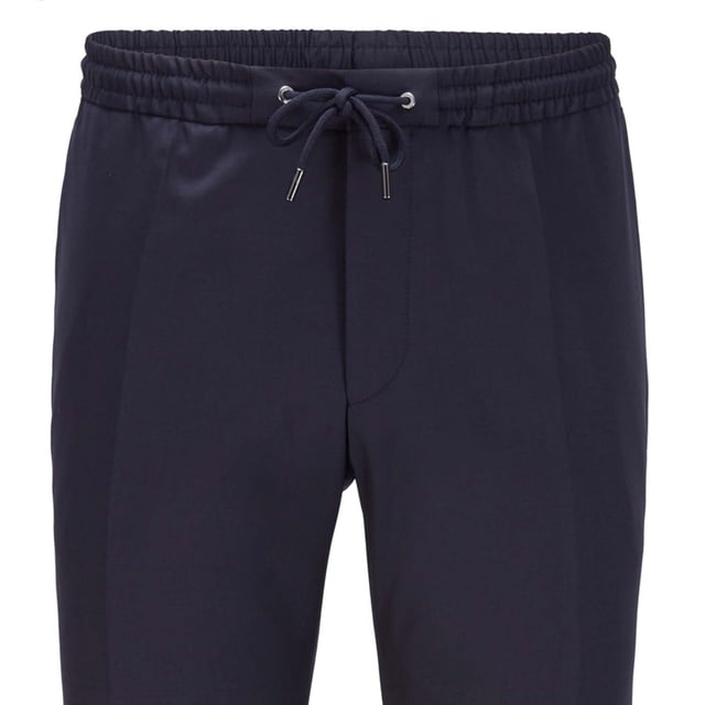 Mens BOSS Banks Trousers in dark blue.- Elasticated drawcord waist.- Button and zip closure.- French pocket.- Jet pocket.- Serge-woven wool.- Slim fit.- Main material: 100% Virgin wool  Lining: 100% Viscose.  Dry clean only.- Ref: 50403896401