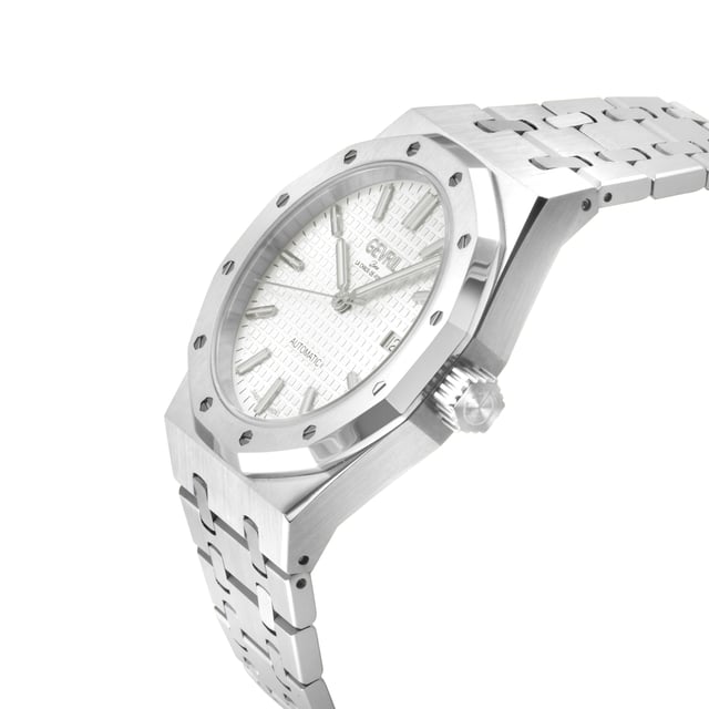 The Gevril Gotham Men’s Watch is a bold celebration of luxury and urban sophistication, drawing inspiration from the exclusive Gotham neighborhood and its prestigious Park Row district. Known for its stately architecture and as a haven for New York’s elite, Park Row epitomizes a legacy of wealth, power, and refinement—qualities embodied in this remarkable timepiece. Crafted with meticulous attention to detail, the Gotham Watch features a 41mm round case, accentuated by a rich top ring that evokes the gleam of opulent cityscapes. The embossed dial, adorned with elegant detailing, mirrors the understated grandeur of Park Row’s historic façades and its harmonious blend of tradition and modernity. A day display positioned at 3 o’clock enhances its practicality, reflecting the precision demanded by those who command time and success. The push/pull hexagon crown, a signature of strength and distinctiveness, and the exhibition case back offer a glimpse into the Swiss-made Sellita SW200-1 automatic movement, a testament to the timepiece's exceptional craftsmanship. The stainless-steel satin bracelet, secured by a deployment buckle, combines durability with an effortless sense of style, reminiscent of the polished sophistication that defines Park Row’s affluence. Protected by an anti-reflective sapphire crystal and water-resistant up to 100 meters, the Gotham Watch is as resilient as the city it represents. It is designed for the discerning gentleman who seeks a timepiece that embodies both function and artistry—a watch that resonates with the rhythm of New York City, where ambition meets elegance. The Gevril Gotham Men’s Watch is more than a timepiece; it is a statement. With every glance, it serves as a reminder of Park Row’s legacy and the wearer’s connection to a world of luxury, power, and prestige.