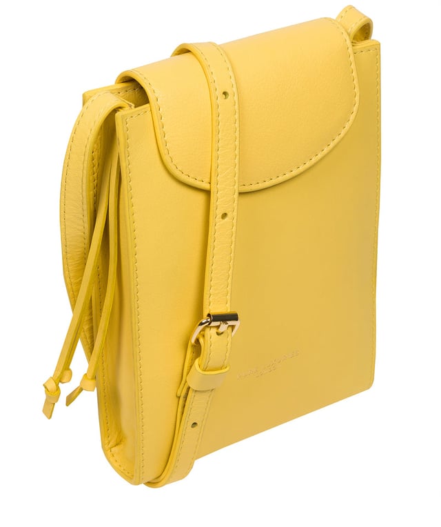 The 'Kiana' cross body phone bag from the Pure Luxuries Marylebone Collection is handcrafted from high-quality, genuine Nappa leather with a natural super-soft touch. The minimalistic fold-over top is secured by a gold-coloured magnetic press stud. This practical design is the perfect place to keep your phone safe and features a tassel design on the exterior. Lined with 100% cotton for a flawless finish and comes with a matching and adjustable slim leather strap with a maximum drop length of 65cm. The minimalist Pure Luxuries logo is embossed in gold foil for a beautifully simple finishing touch.