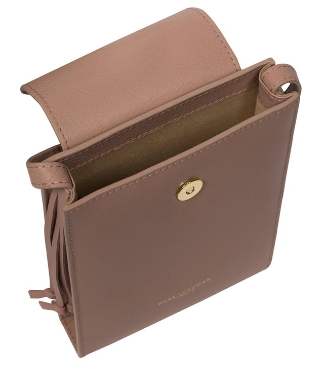 The 'Kiana' cross body phone bag from the Pure Luxuries Marylebone Collection is handcrafted from high-quality, genuine Nappa leather with a natural super-soft touch. The minimalistic fold-over top is secured by a gold-coloured magnetic press stud. This practical design is the perfect place to keep your phone safe and features a tassel design on the exterior. Lined with 100% cotton for a flawless finish and comes with a matching and adjustable slim leather strap with a maximum drop length of 65cm. The minimalist Pure Luxuries logo is embossed in gold foil for a beautifully simple finishing touch.