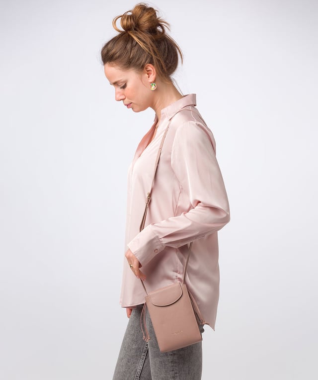 The 'Kiana' cross body phone bag from the Pure Luxuries Marylebone Collection is handcrafted from high-quality, genuine Nappa leather with a natural super-soft touch. The minimalistic fold-over top is secured by a gold-coloured magnetic press stud. This practical design is the perfect place to keep your phone safe and features a tassel design on the exterior. Lined with 100% cotton for a flawless finish and comes with a matching and adjustable slim leather strap with a maximum drop length of 65cm. The minimalist Pure Luxuries logo is embossed in gold foil for a beautifully simple finishing touch.