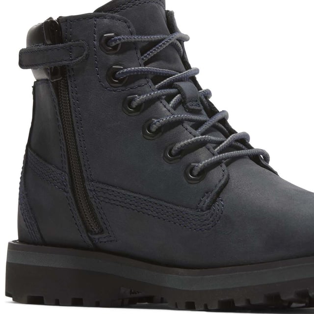 Juniors Timberland Courma Kik Mid Lace-Up Boots in navy.- Upper made with Premium Timberland® Leather. Timberland supports responsible manufacturing of leather via the Leather Working Group.- Traditional lace closure and convenient side zip.- Does it Fit? sockliner.- OrthoLite® footbed.- 100% recycled PET laces.- EVA midsole.- ReBOTL™ fabric lining containing 50% recycled PET plastic.- Rubber outsole.- Ref: A6BK6EP81