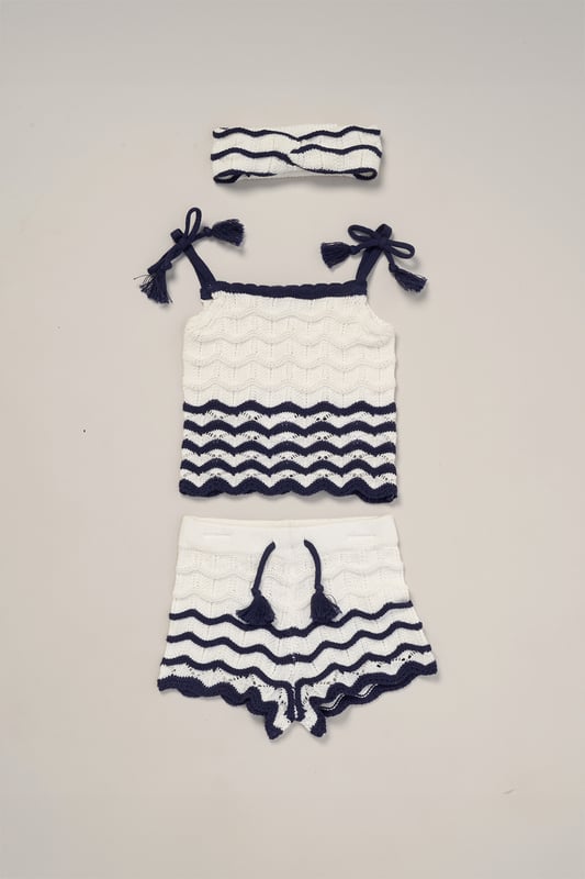 This adorable set by Miss includes a true knit top, comfy shorts, and a matching headband. Perfect for warm days, it combines style and practicality, making it an ideal choice for playdates, outings, or casual summer looks.