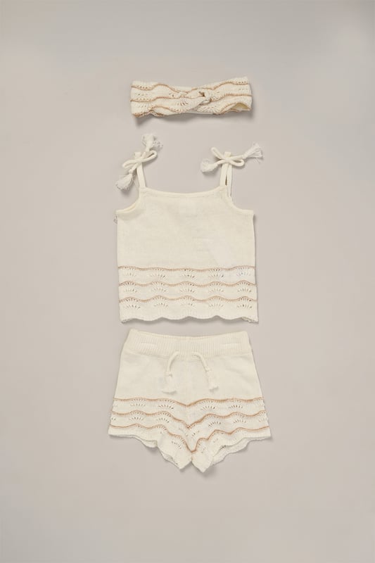 This adorable set by Miss includes a true knit top, comfy shorts, and a matching headband. Perfect for warm days, it combines style and practicality, making it an ideal choice for playdates, outings, or casual summer looks.