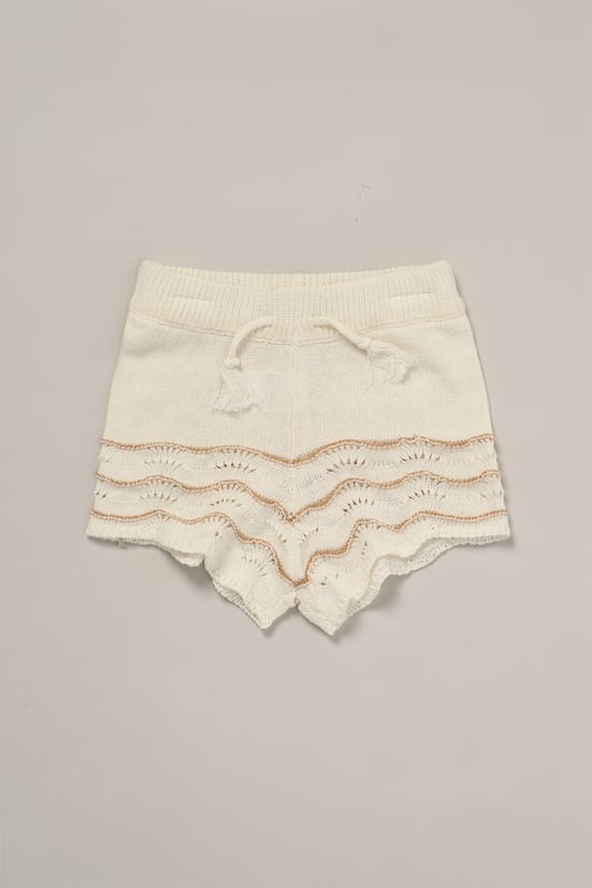 This adorable set by Miss includes a true knit top, comfy shorts, and a matching headband. Perfect for warm days, it combines style and practicality, making it an ideal choice for playdates, outings, or casual summer looks.