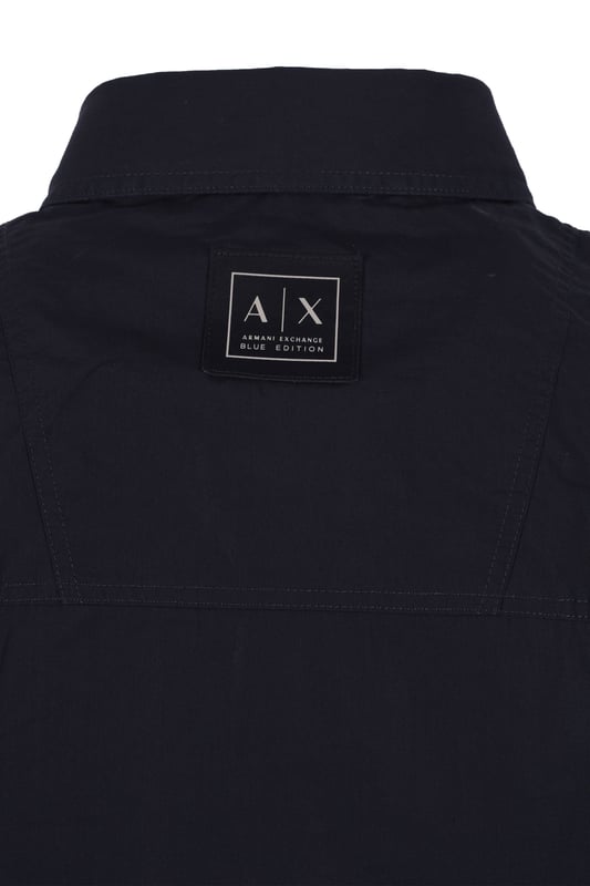 Armani Exchange Long Sleeved Shirt in Deep Navy
Elevate your wardrobe with the Armani Exchange Deep Navy Long-Sleeved Cotton Poplin Shirt. This regular-fit shirt is the epitome of classic style, offering a refined look suitable for any occasion.
 
Crafted from premium cotton poplin, this shirt provides exceptional freshness and comfort, while maintaining a crisp, structured appearance throughout the day. The deep navy hue adds a touch of understated sophistication, making it a versatile staple for both professional and casual settings.
 
Features

Fabric: 100% Cotton
Regular Fit
Cotton Poplin Fabric
Classic Collar
Cuffs with Slit
Back Yoke
Style code: XM000374