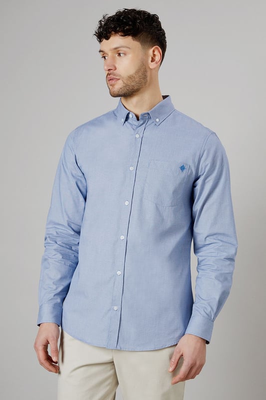 Textured woven fabric for added visual interest
        Button-down collar for a classic look
        Long sleeves with buttoned cuffs
        Subtle embroidered logo on the chest
        Back yoke with centre pleat for enhanced comfort
    
    This Maine long sleeve shirt offers a perfect blend of style and versatility for the modern British gent. The textured fabric adds a touch of sophistication to your casual wardrobe, making it ideal for various occasions. Pair it with chinos and white trainers, as shown, for a relaxed yet put-together look perfect for family gatherings or weekend outings. The button-down collar and clean lines allow for easy transition from day to night, making it a go-to choice for impromptu after-work drinks. For a smart-casual ensemble, layer it under a navy blazer and team with dark denim jeans. The subtle embroidered logo adds a refined touch without being overstated, embodying the understated elegance of British style. Whether you're heading to a casual business meeting or a laid-back dinner with friends, this shirt will ensure you look effortlessly stylish.