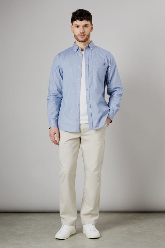 Textured woven fabric for added visual interest
        Button-down collar for a classic look
        Long sleeves with buttoned cuffs
        Subtle embroidered logo on the chest
        Back yoke with centre pleat for enhanced comfort
    
    This Maine long sleeve shirt offers a perfect blend of style and versatility for the modern British gent. The textured fabric adds a touch of sophistication to your casual wardrobe, making it ideal for various occasions. Pair it with chinos and white trainers, as shown, for a relaxed yet put-together look perfect for family gatherings or weekend outings. The button-down collar and clean lines allow for easy transition from day to night, making it a go-to choice for impromptu after-work drinks. For a smart-casual ensemble, layer it under a navy blazer and team with dark denim jeans. The subtle embroidered logo adds a refined touch without being overstated, embodying the understated elegance of British style. Whether you're heading to a casual business meeting or a laid-back dinner with friends, this shirt will ensure you look effortlessly stylish.