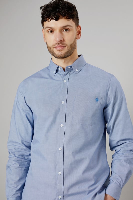 Textured woven fabric for added visual interest
        Button-down collar for a classic look
        Long sleeves with buttoned cuffs
        Subtle embroidered logo on the chest
        Back yoke with centre pleat for enhanced comfort
    
    This Maine long sleeve shirt offers a perfect blend of style and versatility for the modern British gent. The textured fabric adds a touch of sophistication to your casual wardrobe, making it ideal for various occasions. Pair it with chinos and white trainers, as shown, for a relaxed yet put-together look perfect for family gatherings or weekend outings. The button-down collar and clean lines allow for easy transition from day to night, making it a go-to choice for impromptu after-work drinks. For a smart-casual ensemble, layer it under a navy blazer and team with dark denim jeans. The subtle embroidered logo adds a refined touch without being overstated, embodying the understated elegance of British style. Whether you're heading to a casual business meeting or a laid-back dinner with friends, this shirt will ensure you look effortlessly stylish.