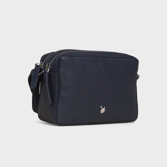 Redefine elegance with the ‘Avon’ soft Nappa leather crossbody bag, a perfect fusion of luxury, craftsmanship, and practicality. Expertly handcrafted from the finest full-grain soft Nappa leather, this premium bag is designed for those who appreciate timeless sophistication and effortless style. Whether you're heading to work, a casual outing, or an evening event, the ‘Avon’ crossbody bag is your go-to accessory for effortless sophistication and refined style. Premium Full-Grain Nappa Leather – Crafted from the softest and most supple genuine leather, offering a luxurious touch and exceptional durability. Smart & Functional Design – Double zipped compartments for easy organisation and secure storage. Spacious interior to accommodate your daily essentials with ease. Adjustable Leather Shoulder Strap – Designed for custom comfort, allowing you to wear it as a crossbody or shoulder bag. Lightweight & Versatile – A perfect everyday companion, seamlessly blending style and functionality. Signature Assots ‘Swan’ Collection – Embellished with the iconic ‘Swan’ logo, symbolising elegance, grace, and superior craftsmanship. Additional Internal Features - Slip-in pocket for your mobile phone, car keys and house keys. Fittings Colour: Silver. Composition: Body: 100% Genuine Leather, Lining: Polyester. Size: 14cm x 20cm x 7cm