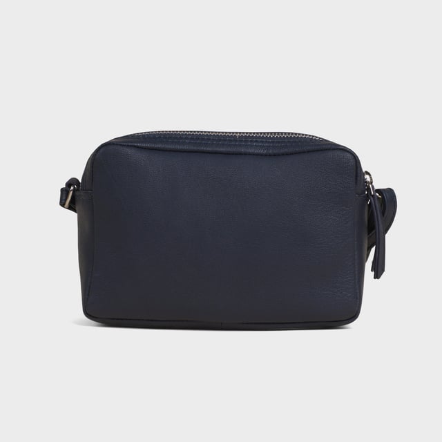 Redefine elegance with the ‘Avon’ soft Nappa leather crossbody bag, a perfect fusion of luxury, craftsmanship, and practicality. Expertly handcrafted from the finest full-grain soft Nappa leather, this premium bag is designed for those who appreciate timeless sophistication and effortless style. Whether you're heading to work, a casual outing, or an evening event, the ‘Avon’ crossbody bag is your go-to accessory for effortless sophistication and refined style. Premium Full-Grain Nappa Leather – Crafted from the softest and most supple genuine leather, offering a luxurious touch and exceptional durability. Smart & Functional Design – Double zipped compartments for easy organisation and secure storage. Spacious interior to accommodate your daily essentials with ease. Adjustable Leather Shoulder Strap – Designed for custom comfort, allowing you to wear it as a crossbody or shoulder bag. Lightweight & Versatile – A perfect everyday companion, seamlessly blending style and functionality. Signature Assots ‘Swan’ Collection – Embellished with the iconic ‘Swan’ logo, symbolising elegance, grace, and superior craftsmanship. Additional Internal Features - Slip-in pocket for your mobile phone, car keys and house keys. Fittings Colour: Silver. Composition: Body: 100% Genuine Leather, Lining: Polyester. Size: 14cm x 20cm x 7cm