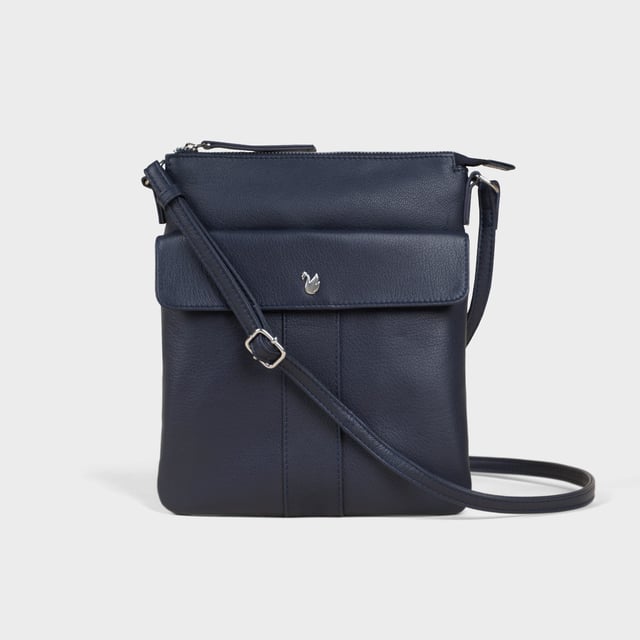 The ‘Amba’ soft Nappa leather crossbody bag blends luxury, craftsmanship, and practicality in a timeless design. Handcrafted from premium full-grain Nappa leather, it’s the perfect companion for work, casual outings, or evening events. Elegant yet versatile, this bag exudes refined sophistication while offering effortless style and functionality. Premium Full-Grain Nappa Leather – Crafted from the softest and most supple genuine leather, offering a luxurious touch and exceptional durability. Smart & Functional Design – Secured zip opens to a roomy main compartment for easy organisation and secure storage. Fully lined with fresh cream polyester fabric to easily spot your essentials. Mulitpockets - Magnetic fastening flap pocket to easily slide in your essentials. Secured back zip pocket provides extra room to organise when you're out and about. Adjustable Leather Shoulder Strap – Designed for custom comfort, allowing you to adjust the length of the strap to suit your needs. Lightweight & Versatile – A perfect everyday companion, seamlessly blending style and functionality. Signature Assots ‘Swan’ Collection – Embellished with the iconic ‘Swan’ logo, symbolising elegance, grace, and superior craftsmanship. Additional Internal Features - Secured zip pocket for your mobile phone, car keys and house keys. Fittings Colour: Silver. Composition: Body: 100% Genuine Leather, Lining: Polyester. Size: 24cm x 21cm x 1.5cm