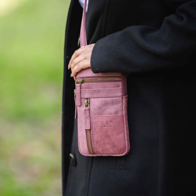 'BROOKE' Real Leather Mobile Phone Crossbody Bag Introducing 'Brooke', the perfect companion for the urban life. Beautifully handcrafted from real leather and with adjustable shoulder handles, its timeless finesse and multi-pocketed design is both elegant and practical, allowing you to move around with effortless grace. The ideal travel crossbody phone bag for everyday use.
One main zip pocket compartment to fit in your daily essentials. Two front zip pockets to slide in your house keys, car keys and more. Front slip pocket to slide in your cardholder. Full length zip pocket at the back to slide in your credit cards, membership cards and more. Adjustable leather shoulder handles for a comfortable carry. Fittings Colour: Antique Brass. Composition: Body: 100% Genuine Leather. Lining: Polyester Mix.
DISCLAIMER : All pictures shown are for illustration purpose only. Actual product colour may vary due to different ambience lighting or the screen display settings. Size- W10.5cm x H18.5cm x D2cm.
