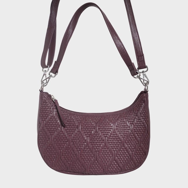 Indulge in luxury with the Assots Premium 'Wonder Weave' Real Leather Woven Designer Shoulder Crossbody Bag. Meticulously crafted with articulate weaving, this bag exudes sophistication and perfection. Its artisanal slot weave creates a unique sense of movement and texture, making it a versatile and luxurious everyday companion. Its versatile design allows it to be worn as a crossbody or shoulder bag, with detachable handles for convenience. Beautiful diamond shaped weaving with the finest full grain genuine leather. Detachable shoulder and crossbody handles to be worn as a crossbody bag or a shoulder bag. Lightweight. Secured zip closure opens to a fully lined and roomy compartment to accommodate all your essentials. Internal zip pocket for your smartphone, house keys and car keys. Available in 13 more elegant colours. Fittings Colour: Silver Nickel. Composition: Body: 100% Genuine Leather, Lining: Polyester. DISCLAIMER: All pictures shown are for illustration purpose only. Actual product colour may vary due to different ambience lighting or the screen display settings. Size- W29cm x H18cm x D8cm.