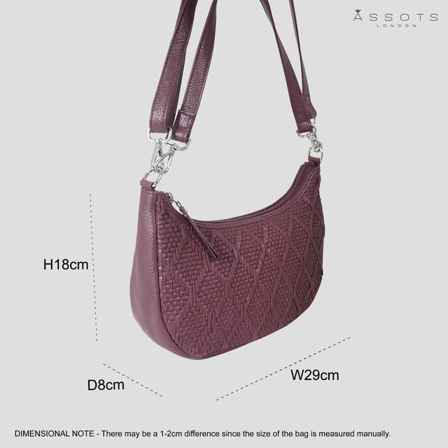 Indulge in luxury with the Assots Premium 'Wonder Weave' Real Leather Woven Designer Shoulder Crossbody Bag. Meticulously crafted with articulate weaving, this bag exudes sophistication and perfection. Its artisanal slot weave creates a unique sense of movement and texture, making it a versatile and luxurious everyday companion. Its versatile design allows it to be worn as a crossbody or shoulder bag, with detachable handles for convenience. Beautiful diamond shaped weaving with the finest full grain genuine leather. Detachable shoulder and crossbody handles to be worn as a crossbody bag or a shoulder bag. Lightweight. Secured zip closure opens to a fully lined and roomy compartment to accommodate all your essentials. Internal zip pocket for your smartphone, house keys and car keys. Available in 13 more elegant colours. Fittings Colour: Silver Nickel. Composition: Body: 100% Genuine Leather, Lining: Polyester. DISCLAIMER: All pictures shown are for illustration purpose only. Actual product colour may vary due to different ambience lighting or the screen display settings. Size- W29cm x H18cm x D8cm.