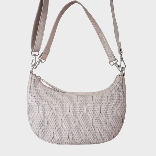Indulge in luxury with the Assots Premium 'Wonder Weave' Real Leather Woven Designer Shoulder Crossbody Bag. Meticulously crafted with articulate weaving, this bag exudes sophistication and perfection. Its artisanal slot weave creates a unique sense of movement and texture, making it a versatile and luxurious everyday companion. Its versatile design allows it to be worn as a crossbody or shoulder bag, with detachable handles for convenience. Beautiful diamond shaped weaving with the finest full grain genuine leather. Detachable shoulder and crossbody handles to be worn as a crossbody bag or a shoulder bag. Lightweight. Secured zip closure opens to a fully lined and roomy compartment to accommodate all your essentials. Internal zip pocket for your smartphone, house keys and car keys. Available in 13 more elegant colours. Fittings Colour: Silver Nickel. Composition: Body: 100% Genuine Leather, Lining: Polyester. DISCLAIMER: All pictures shown are for illustration purpose only. Actual product colour may vary due to different ambience lighting or the screen display settings. Size- W29cm x H18cm x D8cm.