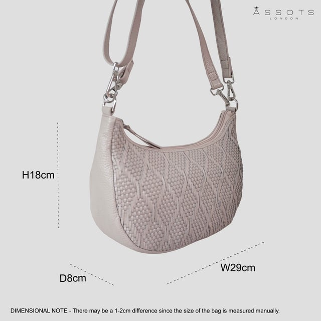 Indulge in luxury with the Assots Premium 'Wonder Weave' Real Leather Woven Designer Shoulder Crossbody Bag. Meticulously crafted with articulate weaving, this bag exudes sophistication and perfection. Its artisanal slot weave creates a unique sense of movement and texture, making it a versatile and luxurious everyday companion. Its versatile design allows it to be worn as a crossbody or shoulder bag, with detachable handles for convenience. Beautiful diamond shaped weaving with the finest full grain genuine leather. Detachable shoulder and crossbody handles to be worn as a crossbody bag or a shoulder bag. Lightweight. Secured zip closure opens to a fully lined and roomy compartment to accommodate all your essentials. Internal zip pocket for your smartphone, house keys and car keys. Available in 13 more elegant colours. Fittings Colour: Silver Nickel. Composition: Body: 100% Genuine Leather, Lining: Polyester. DISCLAIMER: All pictures shown are for illustration purpose only. Actual product colour may vary due to different ambience lighting or the screen display settings. Size- W29cm x H18cm x D8cm.
