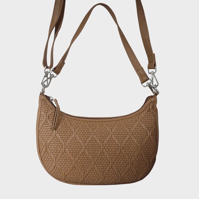 Indulge in luxury with the Assots Premium 'Wonder Weave' Real Leather Woven Designer Shoulder Crossbody Bag. Meticulously crafted with articulate weaving, this bag exudes sophistication and perfection. Its artisanal slot weave creates a unique sense of movement and texture, making it a versatile and luxurious everyday companion. Its versatile design allows it to be worn as a crossbody or shoulder bag, with detachable handles for convenience. Beautiful diamond shaped weaving with the finest full grain genuine leather. Detachable shoulder and crossbody handles to be worn as a crossbody bag or a shoulder bag. Lightweight. Secured zip closure opens to a fully lined and roomy compartment to accommodate all your essentials. Internal zip pocket for your smartphone, house keys and car keys. Available in 13 more elegant colours. Fittings Colour: Silver Nickel. Composition: Body: 100% Genuine Leather, Lining: Polyester. DISCLAIMER: All pictures shown are for illustration purpose only. Actual product colour may vary due to different ambience lighting or the screen display settings. Size- W29cm x H18cm x D8cm.
