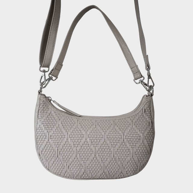 Indulge in luxury with the Assots Premium 'Wonder Weave' Real Leather Woven Designer Shoulder Crossbody Bag. Meticulously crafted with articulate weaving, this bag exudes sophistication and perfection. Its artisanal slot weave creates a unique sense of movement and texture, making it a versatile and luxurious everyday companion. Its versatile design allows it to be worn as a crossbody or shoulder bag, with detachable handles for convenience. Beautiful diamond shaped weaving with the finest full grain genuine leather. Detachable shoulder and crossbody handles to be worn as a crossbody bag or a shoulder bag. Lightweight. Secured zip closure opens to a fully lined and roomy compartment to accommodate all your essentials. Internal zip pocket for your smartphone, house keys and car keys. Available in 13 more elegant colours. Fittings Colour: Silver Nickel. Composition: Body: 100% Genuine Leather, Lining: Polyester. DISCLAIMER: All pictures shown are for illustration purpose only. Actual product colour may vary due to different ambience lighting or the screen display settings. Size- W29cm x H18cm x D8cm.
