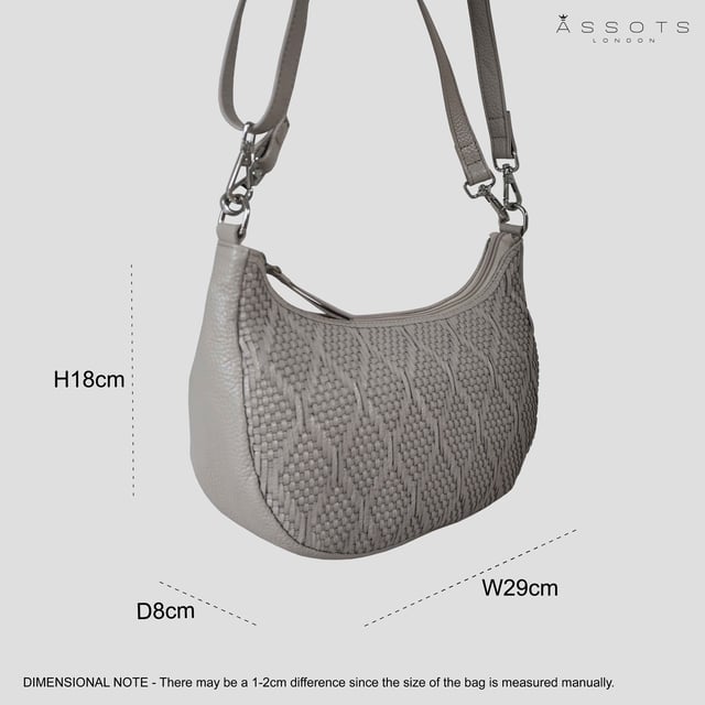 Indulge in luxury with the Assots Premium 'Wonder Weave' Real Leather Woven Designer Shoulder Crossbody Bag. Meticulously crafted with articulate weaving, this bag exudes sophistication and perfection. Its artisanal slot weave creates a unique sense of movement and texture, making it a versatile and luxurious everyday companion. Its versatile design allows it to be worn as a crossbody or shoulder bag, with detachable handles for convenience. Beautiful diamond shaped weaving with the finest full grain genuine leather. Detachable shoulder and crossbody handles to be worn as a crossbody bag or a shoulder bag. Lightweight. Secured zip closure opens to a fully lined and roomy compartment to accommodate all your essentials. Internal zip pocket for your smartphone, house keys and car keys. Available in 13 more elegant colours. Fittings Colour: Silver Nickel. Composition: Body: 100% Genuine Leather, Lining: Polyester. DISCLAIMER: All pictures shown are for illustration purpose only. Actual product colour may vary due to different ambience lighting or the screen display settings. Size- W29cm x H18cm x D8cm.