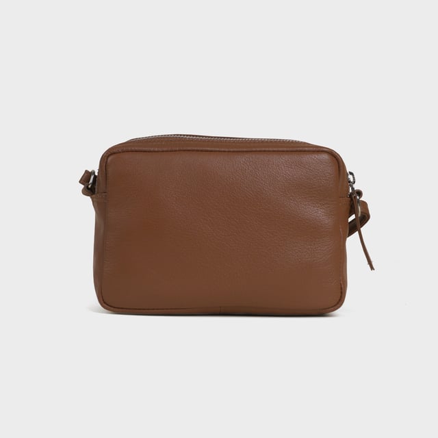 Redefine elegance with the ‘Avon’ soft Nappa leather crossbody bag, a perfect fusion of luxury, craftsmanship, and practicality. Expertly handcrafted from the finest full-grain soft Nappa leather, this premium bag is designed for those who appreciate timeless sophistication and effortless style. Whether you're heading to work, a casual outing, or an evening event, the ‘Avon’ crossbody bag is your go-to accessory for effortless sophistication and refined style. Premium Full-Grain Nappa Leather – Crafted from the softest and most supple genuine leather, offering a luxurious touch and exceptional durability. Smart & Functional Design – Double zipped compartments for easy organisation and secure storage. Spacious interior to accommodate your daily essentials with ease. Adjustable Leather Shoulder Strap – Designed for custom comfort, allowing you to wear it as a crossbody or shoulder bag. Lightweight & Versatile – A perfect everyday companion, seamlessly blending style and functionality. Signature Assots ‘Swan’ Collection – Embellished with the iconic ‘Swan’ logo, symbolising elegance, grace, and superior craftsmanship. Additional Internal Features - Slip-in pocket for your mobile phone, car keys and house keys. Fittings Colour: Silver. Composition: Body: 100% Genuine Leather, Lining: Polyester. Size: 14cm x 20cm x 7cm