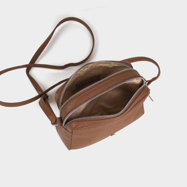 Redefine elegance with the ‘Avon’ soft Nappa leather crossbody bag, a perfect fusion of luxury, craftsmanship, and practicality. Expertly handcrafted from the finest full-grain soft Nappa leather, this premium bag is designed for those who appreciate timeless sophistication and effortless style. Whether you're heading to work, a casual outing, or an evening event, the ‘Avon’ crossbody bag is your go-to accessory for effortless sophistication and refined style. Premium Full-Grain Nappa Leather – Crafted from the softest and most supple genuine leather, offering a luxurious touch and exceptional durability. Smart & Functional Design – Double zipped compartments for easy organisation and secure storage. Spacious interior to accommodate your daily essentials with ease. Adjustable Leather Shoulder Strap – Designed for custom comfort, allowing you to wear it as a crossbody or shoulder bag. Lightweight & Versatile – A perfect everyday companion, seamlessly blending style and functionality. Signature Assots ‘Swan’ Collection – Embellished with the iconic ‘Swan’ logo, symbolising elegance, grace, and superior craftsmanship. Additional Internal Features - Slip-in pocket for your mobile phone, car keys and house keys. Fittings Colour: Silver. Composition: Body: 100% Genuine Leather, Lining: Polyester. Size: 14cm x 20cm x 7cm