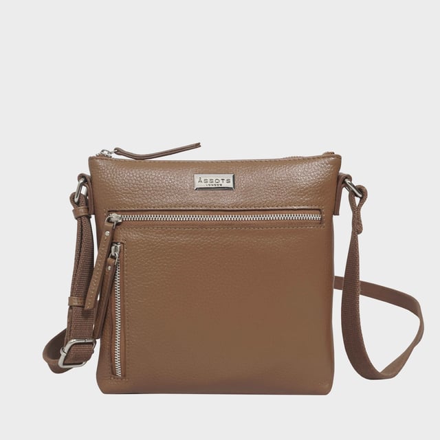 RUE' Soft Pebble Grain Leather Crossbody Bag The Assots timeless design 'Rue' crossbody bag is beautifully handcrafted from the finest & softest pebble grain genuine leather. Effortlessly stylish, this real leather crossbody features four zip pockets to organise your essentials when you're out and about. Ideal as an everyday bag, the 'Rue' is a must-have addition to your collection of luxurious leather handbags. Secured zip top closure opens to a fully lined and roomy interior. Pure cotton fabric lining used in natural beige making it a free from plastic product. Secured two zip pockets at the front to slide in your essentials such as face covering, smart phone and more. Back zip pocket for quick and easy access to your essentials. Adjustable long cotton webbing shoulder strap handle for a comfortable carry. Lightweight. Adorned with the inimitable Assots London clean finish silver metal logo at the front. Fittings colour: Silver Nickel. Composition: Body: 100% Genuine Leather. Lining: Pure Cotton. DISCLAIMER: All pictures shown are for illustration purposes only. Actual product colour may vary due to different ambience lighting or the screen display settings. Size- W22cm x H21cm x D3cm.
