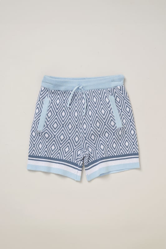 This True Knit resort shirt and shorts set from Norn Studios features a cool patterned design, perfect for summer days and getaways. The lightweight, breathable fabric keeps your little one cool, while the matching shorts complete the relaxed, vacation-ready look. Ideal for sunny adventures and laid-back afternoons.