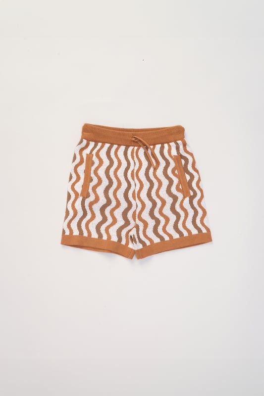 This True Knit resort shirt and shorts set from Norn Studios features a cool patterned design, perfect for summer days and getaways. The lightweight, breathable fabric keeps your little one cool, while the matching shorts complete the relaxed, vacation-ready look. Ideal for sunny adventures and laid-back afternoons.