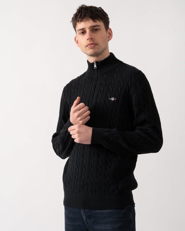 Designed in cotton with an all-over cable knit structure, this soft sweater has a regular fit and sporty half-zip collar. A preppy essential, it is detailed with our iconic GANT shield embroidered at the chest, and ribbed endings at the neck, hem and cuffs.
Regular fitHalf-zip collarCable knit structureGANT graphic embroidered at chest
 
100% Cotton
 