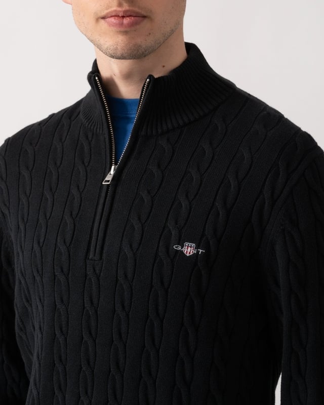 Designed in cotton with an all-over cable knit structure, this soft sweater has a regular fit and sporty half-zip collar. A preppy essential, it is detailed with our iconic GANT shield embroidered at the chest, and ribbed endings at the neck, hem and cuffs.
Regular fitHalf-zip collarCable knit structureGANT graphic embroidered at chest
 
100% Cotton
 