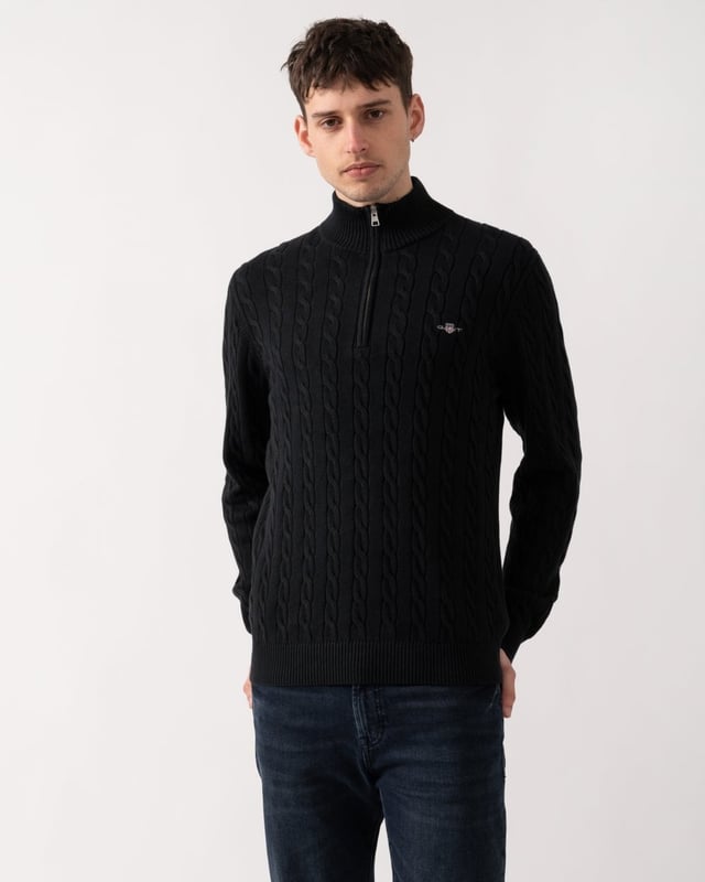 Designed in cotton with an all-over cable knit structure, this soft sweater has a regular fit and sporty half-zip collar. A preppy essential, it is detailed with our iconic GANT shield embroidered at the chest, and ribbed endings at the neck, hem and cuffs.
Regular fitHalf-zip collarCable knit structureGANT graphic embroidered at chest
 
100% Cotton
 