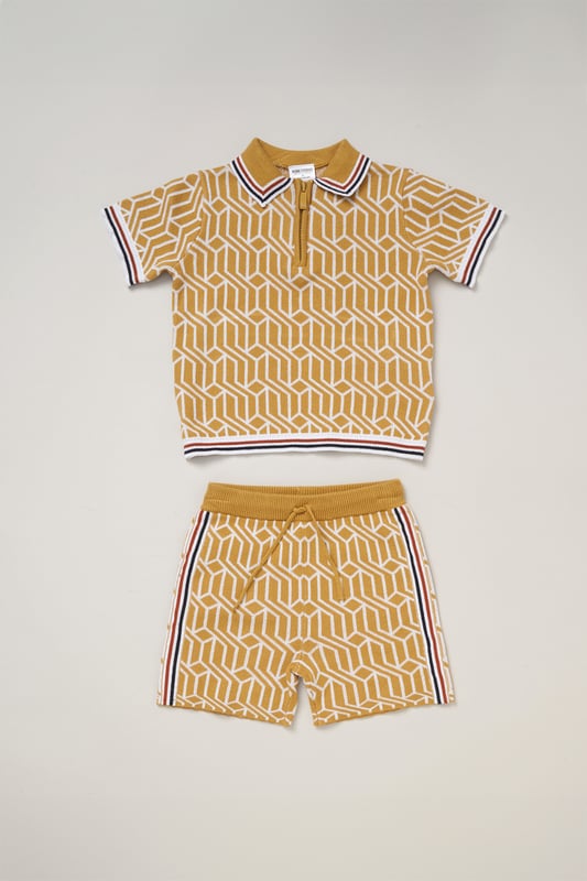 This True Knit patterned polo shirt and matching shorts set from Norn Studios features a stylish design with a drawstring waist for a comfortable fit. Perfect for day or night wear, it combines a classic look with practical comfort, making it an ideal choice for your little one’s casual adventures.