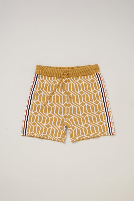 This True Knit patterned polo shirt and matching shorts set from Norn Studios features a stylish design with a drawstring waist for a comfortable fit. Perfect for day or night wear, it combines a classic look with practical comfort, making it an ideal choice for your little one’s casual adventures.