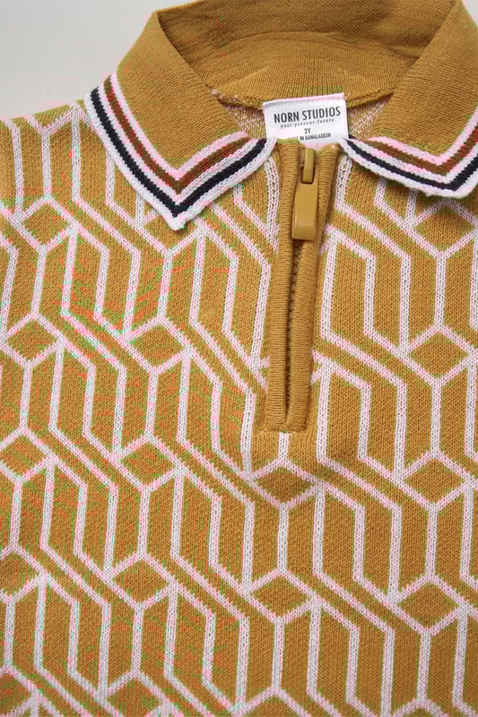 This True Knit patterned polo shirt and matching shorts set from Norn Studios features a stylish design with a drawstring waist for a comfortable fit. Perfect for day or night wear, it combines a classic look with practical comfort, making it an ideal choice for your little one’s casual adventures.