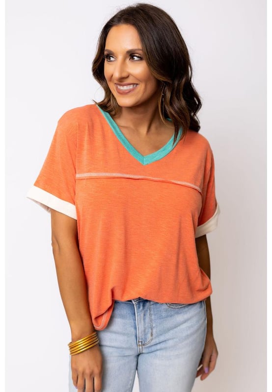 Grapefruit Orange Contrast Trim Exposed Seam
  V Neck T
  shirt
  Trendy contrast trim adds a color block effect
  Visible stitching creates a unique and fashionable look
  V
  neck cut flatters your neckline and adds a feminine touch
  Soft and breathable fabrics
  Perfect for everyday wear
  High elasticity
  Unisex
Material: 65% Polyester 35% Cotton